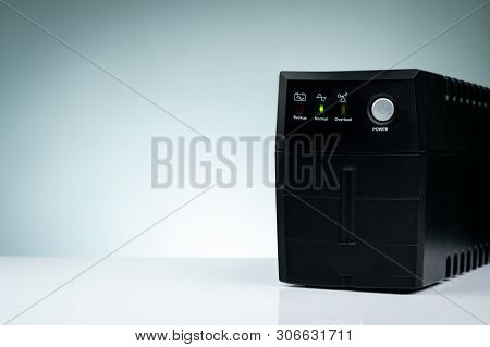 Uninterruptible Power Supply. Backup Power Ups With Battery Isolated On Table. Ups For Pc. Equipment