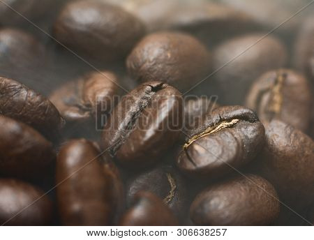 Coffee Beans Fresh Roast With Smoke. Coffee Beans Background.