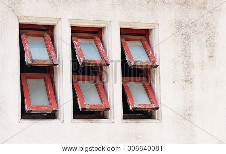 Row Of Old Red Wooden Awning Windows Frame Open In The Morning For Bright Light Streaming Through Th