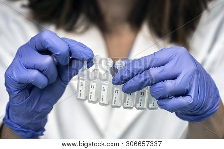 Nurse Prepares Medication In Ampoules For Oxygen Mask In A Hospital, Conceptual Image