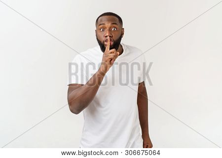 Closeup Portrait Of Handsome Bald Man Placing Finger On Lips As If To Say, Shhhhh, Be Quiet, Silence