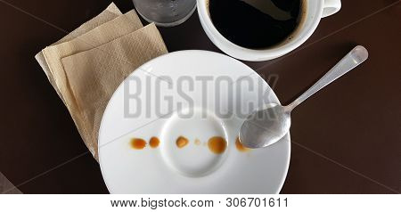 Coffee In Cup And Sprinkled With Drops On A White Plate. Creative Coffee Art Background