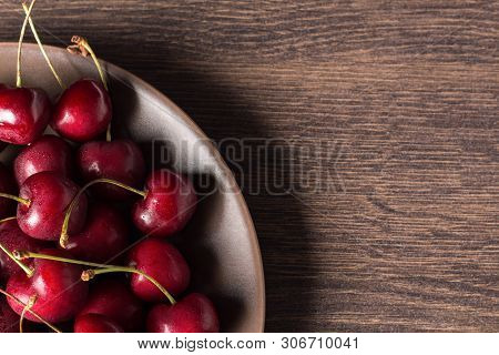 Fresh Cherries On A Brown Plate On A Wooden Table. Summer Food, Healthy Eating. Organic, Vegetarian,