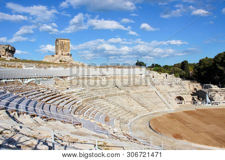 Ancient Greek Theatre Of Syracuse In Sicily, Italy On A Sunny Day. Archaeological Site, Historical L