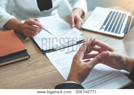 Senior Manager Woman Reading A Resume During A Job Interview Employee Young Man Meeting Applicant An