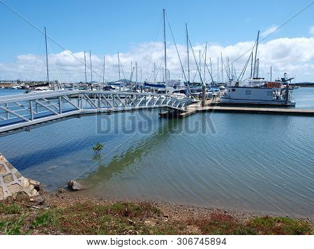Gladstone Marina. Waterfront Walkway With Boats In Tropical Water With Blue Sky Backdrop. Safe Haven