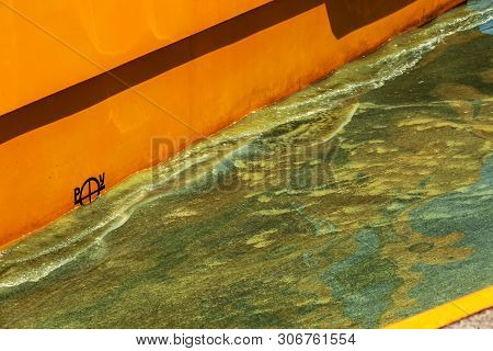Dirty wave with old dirty algae. Dirty seaweed sea surf lines in seaport. Dirty sea, environmental p