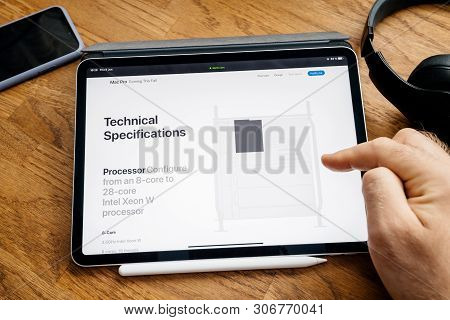 Paris, France - Jun 6, 2019: Man Reading On Apple Ipad Pro Tablet About Latest Announcement Of At De