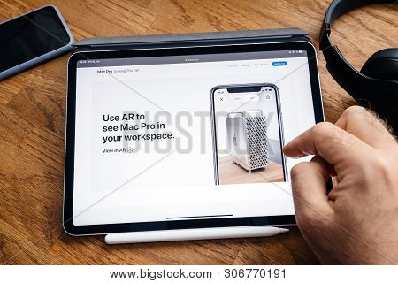 Paris, France - Jun 6, 2019: Man Reading On Apple Ipad Pro Tablet About Latest Announcement Of At De