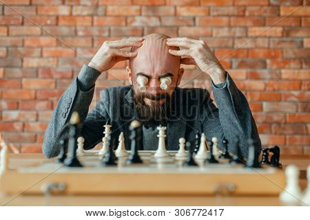 Male chess player with figures in the eyes