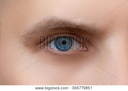 Close-up Of A Blue-eyed Male Eye. Stern And Attentive Look