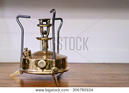 Beauty Primus Stove On Wooden Table. Old Kerosene Primus, Brass Burner Isolated, Royalty High Qualit
