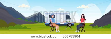 Couple Sitting At Table Near Camping Family Trailer Truck Caravan Car Man Woman Spendingtime Togeher
