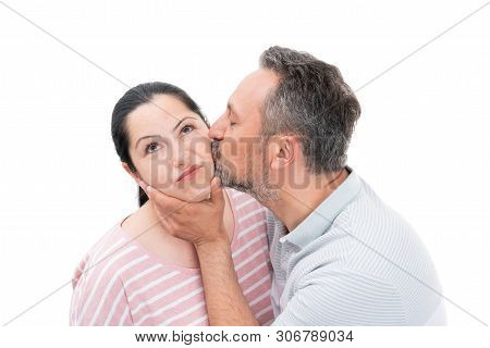 Loving Man Kissing Woman Cheek And Touching Face With Unwilling Expression As Couple Concept Isolate