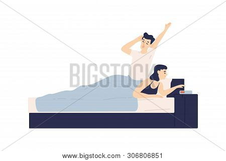 Man Lying In Bed, Yawning And Woman Setting Up Alarm Clock. Young Couple Falling Asleep Or Waking Up