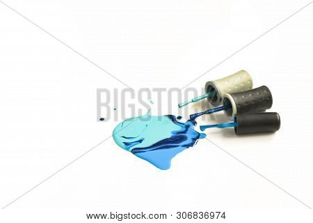 Turquoise And Blue Color Nail Polish Shellac Stain With Tassels Dripping Drops Close Up On A White B