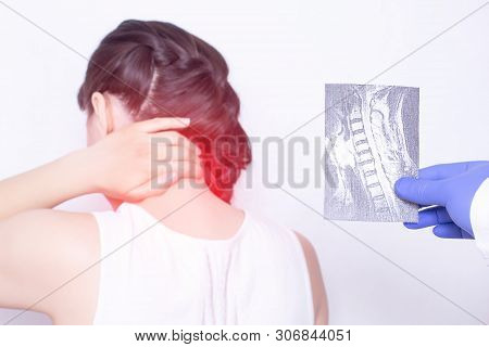 The Doctor Conducts A Medical Examination. She Holds An X-ray Examination Of A Girl Who Has Pain In 