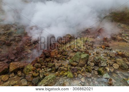 Water Vapor Over The Valley Of Small Geysers. View Of The Eastern Mountain Covered By Clouds, Jelize