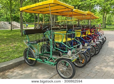 Four Wheel Rental Bikes Lined Up For Pleasure Biking Around The Park
