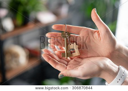 Mortgage Concept. House Key In Womans Hands. Young Woman. Modern Light Lobby Interior. Real Estate, 