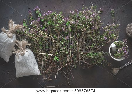 Thyme Flowers, Mortar And Sachets Full Of Thymus Serpyllum Medicinal Herbs. Top View.