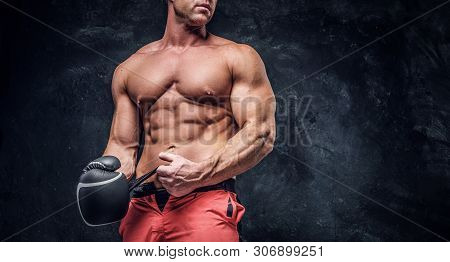 Serious Muskular Man Get Prepared For Boxing, His Is Wearing His Boxer Gloves.