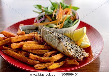 A Typical Aussie Pub Meal Of Grilled Fish, Chips And Salad Served In An Australian Hotel
