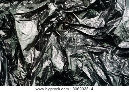 Black Plastic Garbage Bag Texture. Abstract Wrinkled Background Of Plastic Garbage