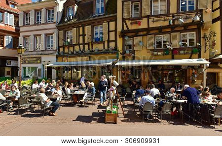 Colmar, France - April 18, 2019. Overcrowded Restaurant In The Old Half-timbered House, Decorated Wi