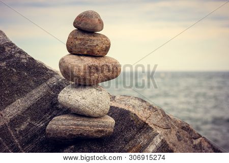 The Stones Pyramid On The Lake. Nature Background