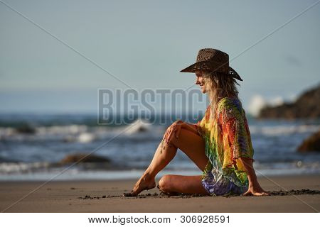 young woman relaxing on the beach in summer day