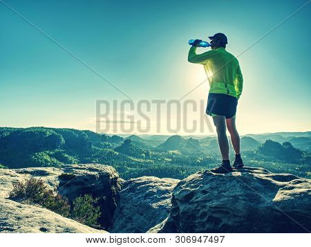 Sports Bottle Drink Sport Man Drinking Water On Trail Run. Male Runner Sweaty And Thirsty After Diff