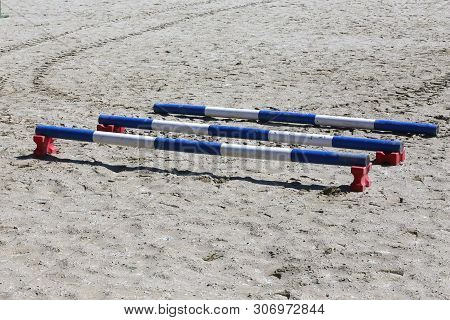Image Of Show Jumping Poles On The Training Field. Wooden Barriers For Jumping Horses As A Backgroun