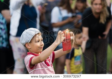 Ivano-frankivsk Reg, Ukraine - Jun. 15, 2019: Boy With A Smartphone At The Festival Polonynsky Summe