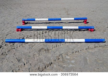 Image Of Show Jumping Poles On The Training Field. Wooden Barriers For Jumping Horses As A Backgroun