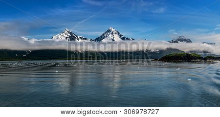 Low Clouds Over The Snow Capped Mountains Near The Glaciers Of Aialik Bay In Knai Fjords National Pa