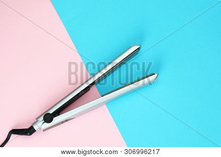 Modern Hair Iron For Straightening On Color Background, Top View