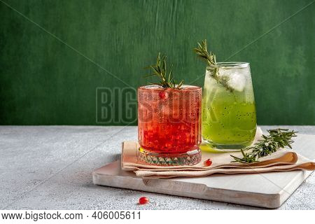 Two Colorful Summer Cocktails In Glasses On Grey Table. Assortment Of Fresh Summer Drinks. Red Sangr