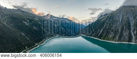 Aerial Panorama Drone Shot Of Schlegeisspeicher Resevoir With Galcier View At Dusk