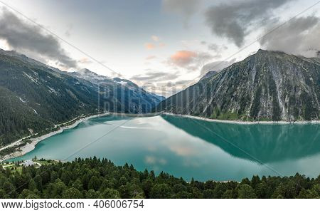 Aerial Drone Shot Of Schlegeisspeicher Resevoir With Galcier View At Dusk