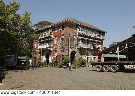 Yangon, Myanmar - December 19, 2019: An Old Housing Block, Still Inhabited, And In Poor Condition, I