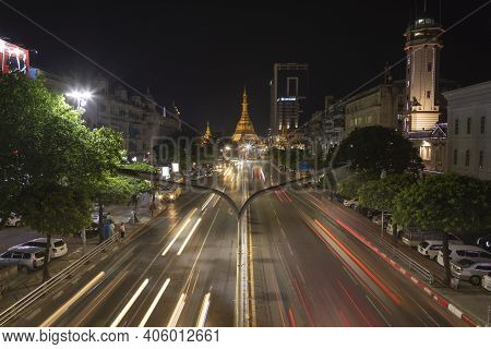 Yangon, Myanmar - December 19, 2019: Detail Of Night Traffic Towards Sule Pagoda Buddhist Temple And