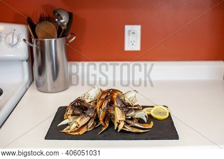 Raw, Cleaned, Uncooked Dungeness Crab Legs Sit On A Platter In The Kitchen Ready To Be Cooked For Di
