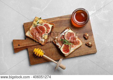 Delicious Sandwiches With Figs, Proscuitto And Cheese On Light Table, Top View