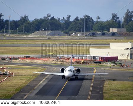 Honolulu - January 23, 2015: Aerial Of Airplane Driving Down The Runway At Honolulu International Ai