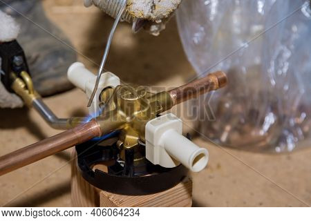 Blue Flame Torch Soldering A Brass Diverter For Shower Bathtub On Water System.