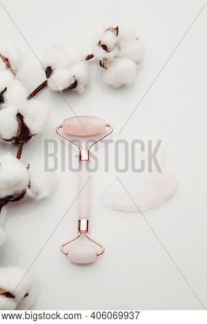 Pink Gua Sha Massage Tool. Facial Skin Care At Home, Anti-aging And Lifting Therapy. Vertical Image