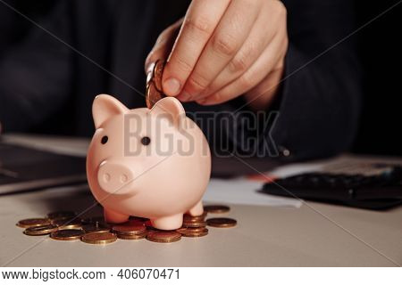 Scattered Coins And Pink Piggy Bank At The Desk. Finance And Business Concept
