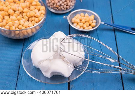 Close-up Of A White Whipped Chickpea Aquafaba On A Blue Background. Aquafaba Is A Great Substitute F