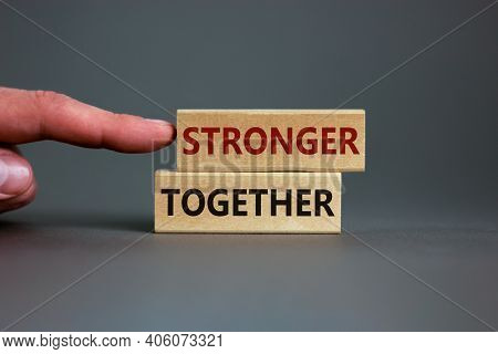 Stronger Together Symbol. Concept Words 'stronger Together' On Wooden Blocks On A Beautiful Grey Bac